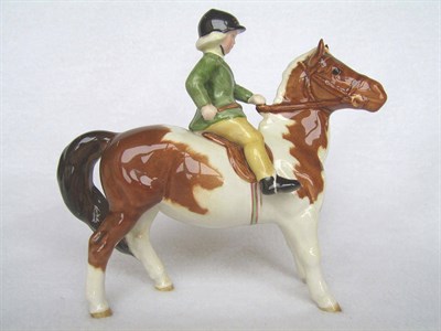 Lot 280 - Beswick Girl on Skewbald Pony, model No. 1499, brown and white pony, rider in green jacket...