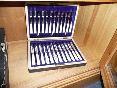 Lot 315 - A set of twelve silver dessert knives and forks, cased