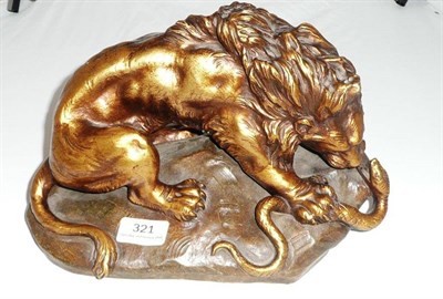 Lot 321 - After Fagotto (Belgian) a bronzed terracotta model of a lion wrestling with a snake on a...