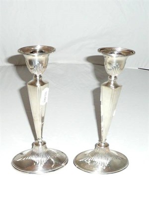 Lot 323 - A pair of silver loaded candlesticks