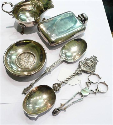 Lot 334 - Spirit flask, sauce boat, two spoons, tongs, two silver coin ashtrays