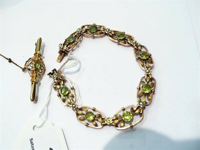 Lot 335 - A 15 carat gold peridot and seed pearl brooch and a peridot and seed pearl bracelet (a.f.)