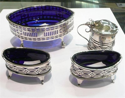 Lot 342 - A silver sweetmeat dish with blue glass liner and a similar silver three piece condiment set