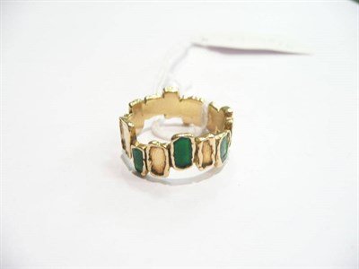 Lot 355 - An 18 carat gold and green enamel ring