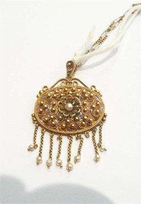 Lot 393 - A yellow gold filigree and seed pearl pendant with a two colour gold chain