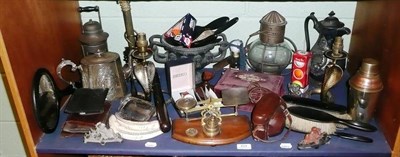 Lot 414 - Shelf of metal ware and other items including pair of brass cobra table lamps, other lamps, spelter