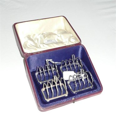 Lot 451 - Cased set of four silver toast racks