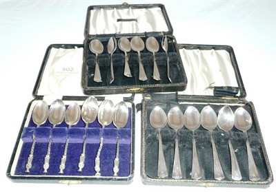 Lot 502 - Six apostle top silver teaspoons and a set of twelve silver coffee spoons in two cases