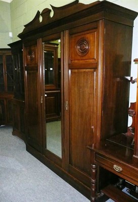 Lot 601 - A Late 19th/early 20th century four piece mahogany bedroom suite comprising of a triple door...