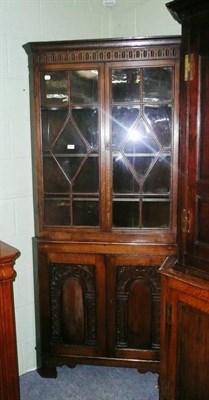 Lot 603 - A reproduction oak corner cupboard, floor standing with astragal glazed upper section