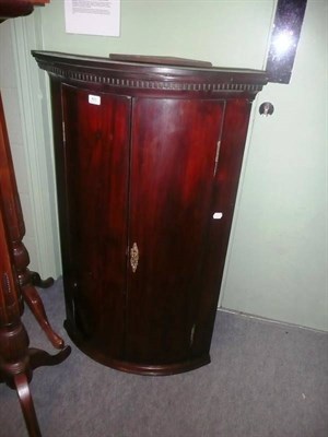 Lot 611 - Georgian mahogany bow-fronted corner cupboard