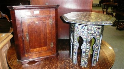 Lot 613 - A small oak hanging corner cupboard and an octagonal floral decorated Eastern table together...