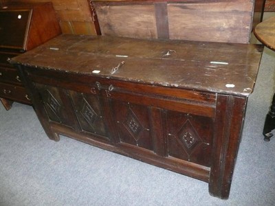 Lot 638 - A heavy oak four panel coffer with lozenge moulded front