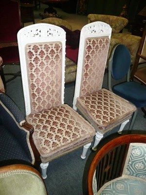 Lot 664 - Pair of white painted gilt Victorian high back chairs