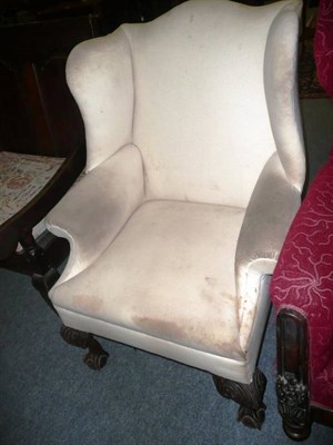 Lot 680 - Wing armchair on claw and ball feet