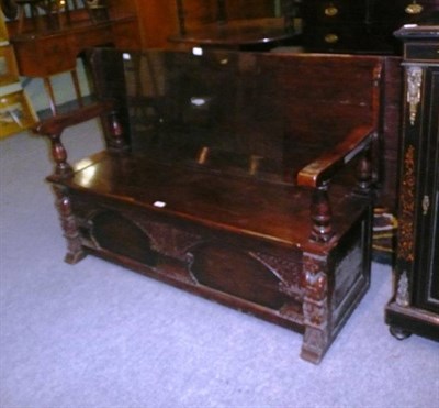 Lot 689 - Carved oak boxed settle