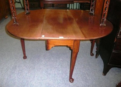 Lot 700 - A George III mahogany drop leaf pad foot dining table