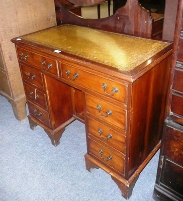 Lot 714 - A reproduction yew wood kneehole pedestal desk