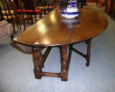 Lot 731 - A Bryn Hall large oak drop leaf dining table (Bryn Hall is based in Wales)