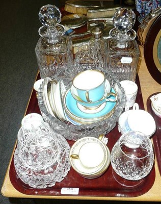 Lot 25 - A quantity of cups and saucers, two decanters, two glass bowls and a circular embroidered picture