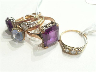 Lot 95 - A diamond three stone ring and a diamond solitaire ring and three stone-set rings
