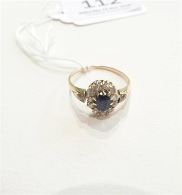 Lot 112 - A sapphire and diamond cluster ring