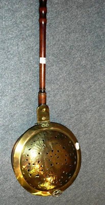 Lot 134 - Georgian brass warmer with turned handle