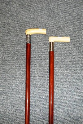 Lot 146 - Two ivory handled malacca walking sticks with silver collars