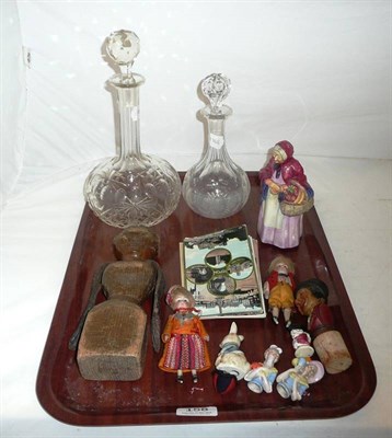 Lot 158 - Tray including two small bisque dolls, wooden doll, postcards, Coalport figure, two decanters etc