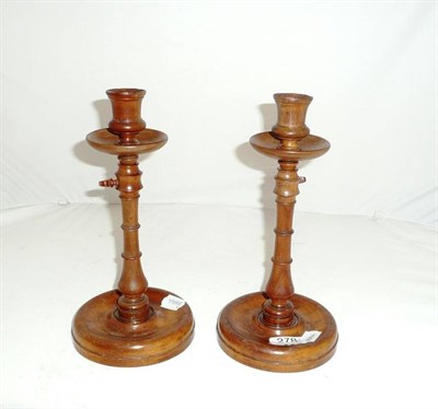 Lot 278 - A pair of turned treen adjustable candlesticks