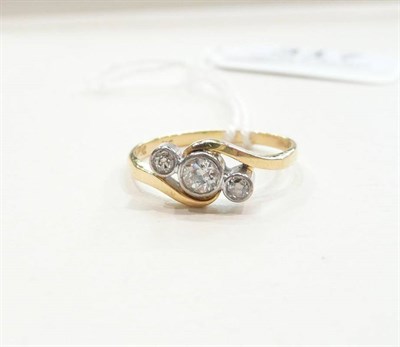 Lot 317 - An 18ct gold diamond three stone twist ring