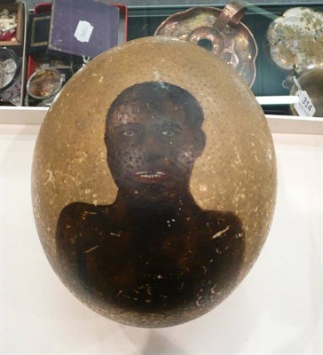 Lot 324 - A 19th century decorated ostrich egg titled 'A Little Brown Boy'