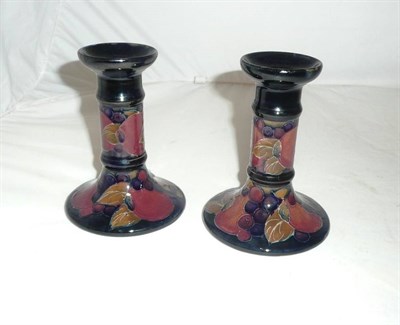 Lot 352 - A pair of William Moorcroft "Pomegranate" candlesticks