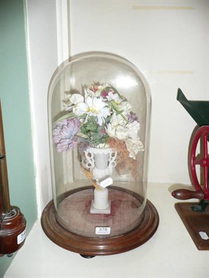 Lot 376 - An alabaster urn, silk flowers and glass dome