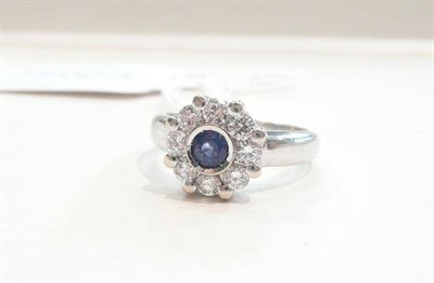 Lot 380 - A sapphire and diamond cluster ring, white shank stamped '750' (and cracked)