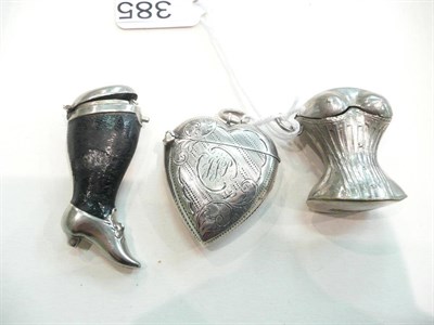 Lot 385 - A silver heart shape vesta case, a novelty vesta case as a basque and another as a lady's leg (3)