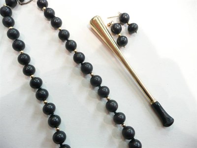 Lot 397 - A 9ct gold cigarette holder and a strand of beads with matching earrings