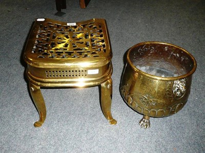 Lot 431 - A Brass Footman, early 19th century, the wheel and fence fretted top on front cabriole legs,...