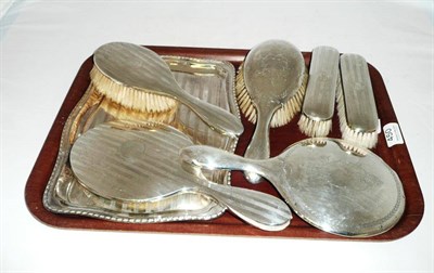 Lot 450 - A four piece silver dressing set, a plated tray, a mirror and a brush