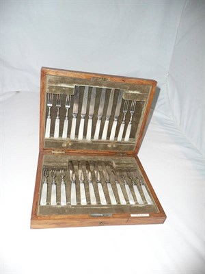 Lot 451 - A set of twelve mother-of-pearl handled silver fruit knives and forks in a fitted oak case (one...