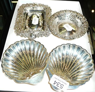 Lot 534 - Two silver shell butter dishes and two embossed silver dishes