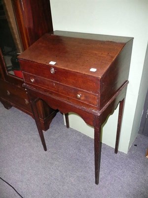 Lot 573 - An oak desk box with hinged slope and stand