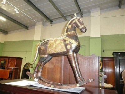 Lot 608 - An Eastern carved rocking horse with brass and copper mounts