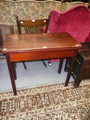 Lot 627 - A George III mahogany fold-over tea table, circa 1800, the rectangular hinged top above a plain...