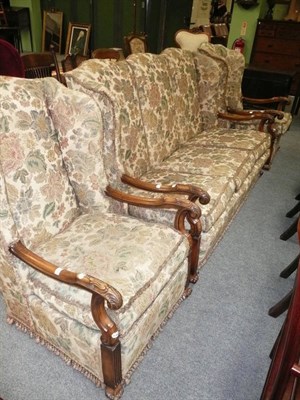 Lot 630 - A walnut three piece suite of a settee and two armchairs and two further red upholstered side...