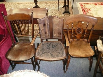 Lot 631 - Bergere elbow chair, spindle rocking chair and a wheel-back kitchen chair