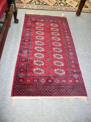 Lot 676 - A machine made rug of Turkman design