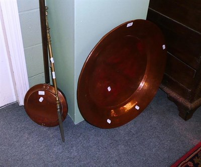 Lot 732 - A large copper dish, a bed warming pan and a poker