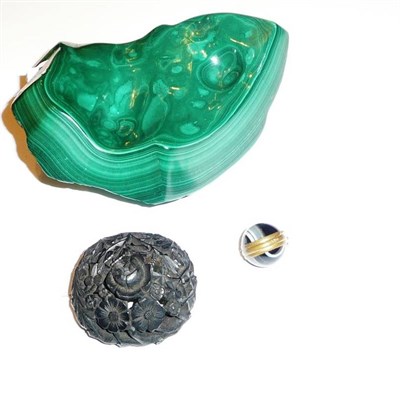 Lot 65 - A carved jet brooch, a spherical banded agate locket and a piece of polished malachite