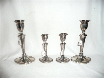 Lot 84 - Two pairs of silver plated classical candlesticks